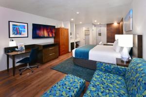 a hotel room with a bed and a desk at Old Town Inn in San Diego
