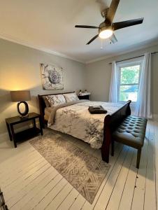 a bedroom with a bed and a ceiling fan at Historic Charlottetown Twin Towers in Charlottetown