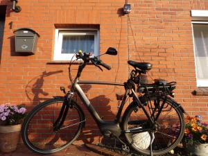 a bike parked next to a brick wall at At the Leaning Tower Comfortable holiday residence in Suurhusen
