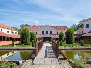 a bridge over a pond in front of a building at Stadtvilla Laux Comfortable holiday residence in Merzig