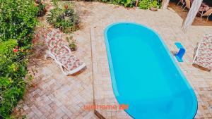 an overhead view of a swimming pool and two chairs at Casa em Ilheus com Piscina Próxima a Praia in Ilhéus
