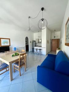 een woonkamer met een blauwe bank en een tafel bij La Casa Lungo Il Mare in Maiori
