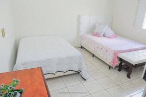 Una cama o camas en una habitación de Chácara Salone
