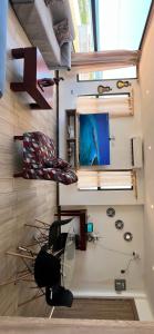 a room with a chair and a tv on a wall at CONDOMINIO MIRAMAR VISTA AL MAR Playas villamil in Playas