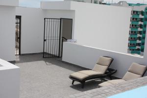 a waiting room with two chairs and a mirror at 2br 1ba Condo 1 block to ocean Condo 1 in Mazatlán