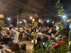 a crowd of people sitting in chairs in a room at Hostal Santiago DC in Cali