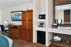 a hotel room with a bed and a desk at Old Town Inn in San Diego