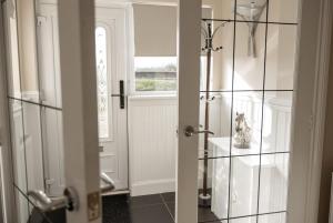 a bathroom with a shower with a glass door at Spacious 3 Bed Home in Glasgow City With Free Parking in Glasgow +30 photos