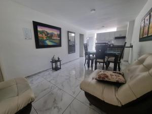 a living room with a couch and a table in it at Apartahotel Rubí San Gil in San Gil