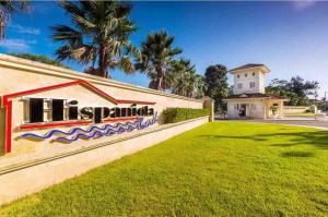 a house with a sign that reads hisparilla at Hispañola Beach Beautiful condo with private beach two bedrooms in Sosúa