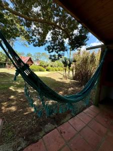 a hammock hanging from a porch in a yard at Cabañas Country in La Paloma +3 photos