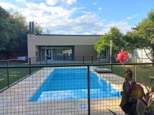 a swimming pool in front of a building at El Descanso Melincue in Melincué