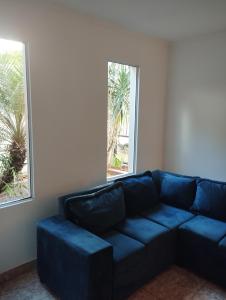 a blue couch in a room with two windows at Brisas Iguazú II in Puerto Iguazú +18 photos