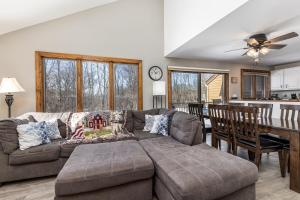 a living room with a couch and a dining room at 4-Bedroom Townhouse in Beautiful Galena in Galena