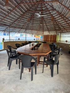 a large wooden table and chairs under a roof at Sea View in Meedhoo
