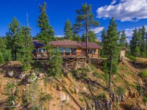 a house on top of a hill with trees at Amazing views near Strawberry Point! in Duck Creek Village