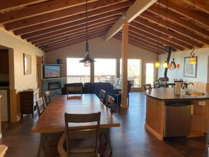 a kitchen and living room with a table and chairs at Amazing views near Strawberry Point! in Duck Creek Village