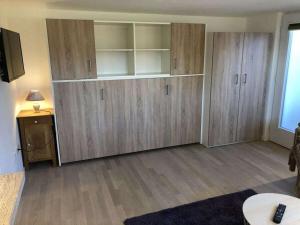 a living room with wooden cabinets and a table at Apartment Grünsberg Comfortable holiday residence in Grünsberg +7 photos