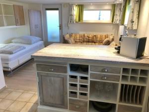 a room with a kitchen with a counter with wine glasses at Apartment Grünsberg Comfortable holiday residence in Grünsberg
