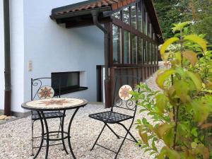 a patio with a table and two chairs and a television at Apartment Grünsberg Comfortable holiday residence in Grünsberg