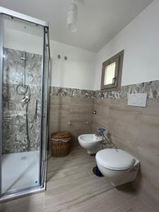 a bathroom with a shower and a toilet and a sink at Catherine's home in Ostuni