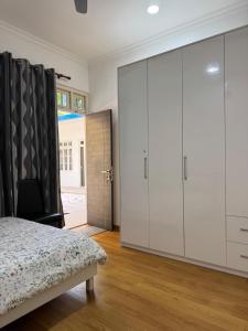 a bedroom with a bed and a large closet at Sea View in Meedhoo