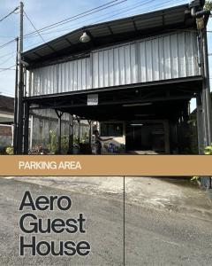 a building with a garage with a guest house at Aero Guest House in Timuran