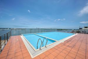 a swimming pool on the roof of a building at BayView Retreat Premium Stay at Marine Drive Kochi in Cochin