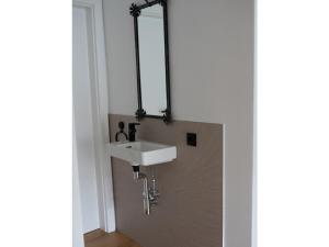 a bathroom with a white sink and a mirror at Apartment Bär Comfortable holiday residence in Eben im Pongau +32 photos