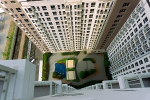 an overhead view of a building with two tall buildings at New and Nice Designed Studio at Tokyo Riverside PIK 2 Apartment By Travelio in Rawalembang