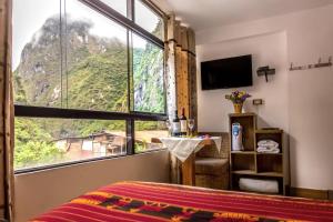 TV a/nebo společenská místnost v ubytování Runas Inn Machupicchu