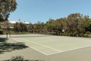 a tennis court with a net on top of it at Whitehaven - 100m to Beach, Private Pool in Yaroomba
