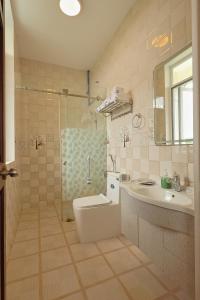 a bathroom with a toilet and a sink and a shower at The Hill An Sơn DIC in Xuan An +29 photos