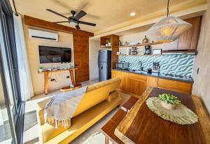 a kitchen and living room with a couch and a table at Luxury Romantic Getaway - 1 Bedroom - Steps from the Beach - Bahia Tankah Tulum in Tulum +50 photos