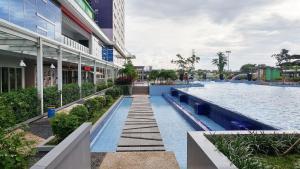 a swimming pool in the middle of a building at Comfy and Best Deal 2BR at Green Pramuka City Apartment By Travelio in Jakarta