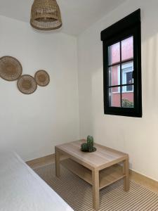 a room with a bed with a table and a window at Aire de Miranda in Cariño