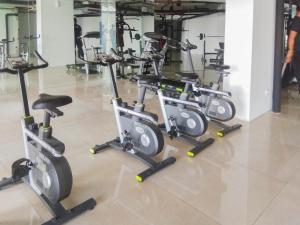 a row of exercise bikes in a gym at Homey and Minimalist 2BR at Patraland Urbano Apartment By Travelio in Bekasi