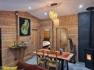 a dining room with wooden walls and a table and chairs at Chalet rénové avec sauna, proche Gérardmer - FR-1-589-796 in Sapois +26 photos