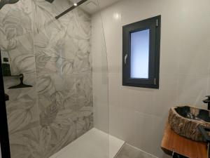 a bathroom with a shower with a window and a sink at Chalet rénové avec sauna, proche Gérardmer - FR-1-589-796 in Sapois