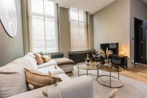 a living room with a couch and a table at Haya Historic - Rosé in The Hague