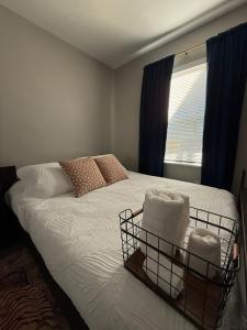 a bedroom with a white bed with a window at Bungalow in San Diego