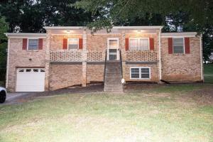 a brick house with a garage and a driveway at COBE Enterprise in Danville