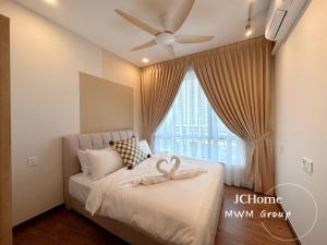 a bedroom with a bed with a ceiling fan at Central Park Stay chill, stay here Netflix House JCHome by MWM in Johor Bahru +29 photos
