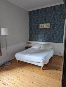 Postel nebo postele na pokoji v ubytování Le Manoir de Conteville