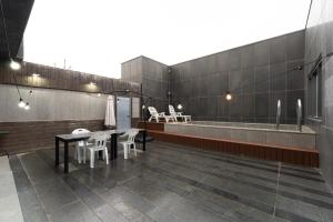 仁川市Browndot Hotel Incheon Songdo的配有桌椅和浴缸的客房