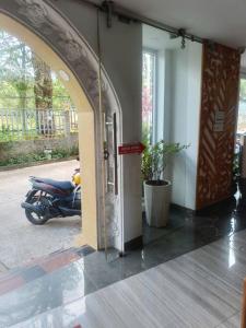 a motorcycle parked next to a building with an open door at Holiday Hotel in Phu Quoc +3 photos