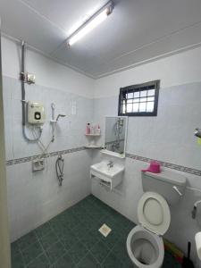 a bathroom with a toilet and a sink at Desa Tebrau 31 ikea AEON 15 paxs in Johor Bahru +17 photos