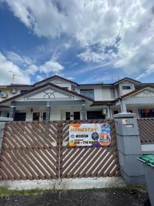 a house with a sign on a fence at Desa Tebrau 31 ikea AEON 15 paxs in Johor Bahru