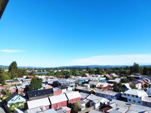 an aerial view of a city with houses at Departamento encanto del sur isla teja in Valdivia