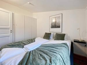 ein Schlafzimmer mit zwei Betten und einem Bild an der Wand in der Unterkunft The Green 20 of Stavanger BnB in Stavanger